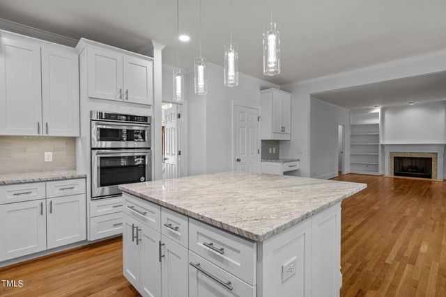 a kitchen with kitchen island a sink stainless steel appliances and cabinets