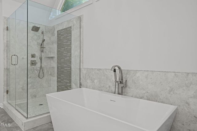 a bathroom with a bathtub and shower