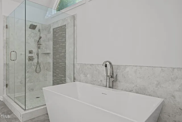 a bathroom with a bathtub and shower