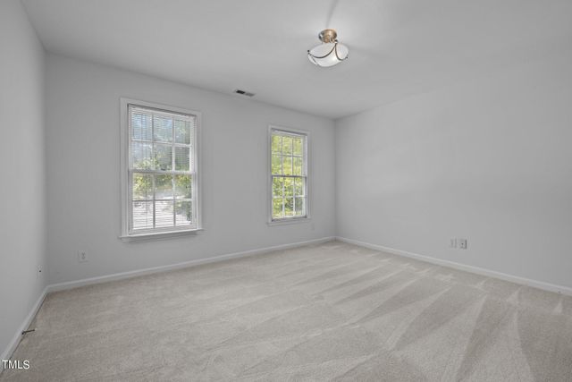 a bedroom with a bed a chair and a window