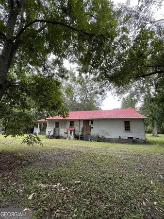a view of a house with a yard and sitting area