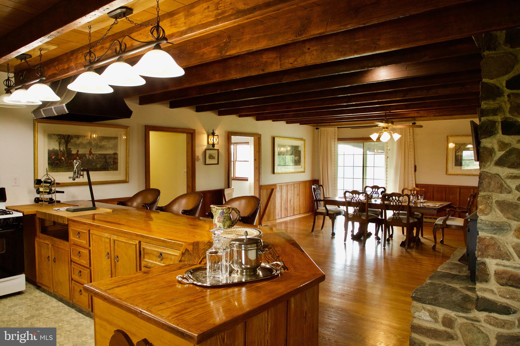 21133 Foxcroft Road Middleburg, VA 20117 - Photo 2 of 41 a view of a dining room with furniture a chandelier and wooden floor