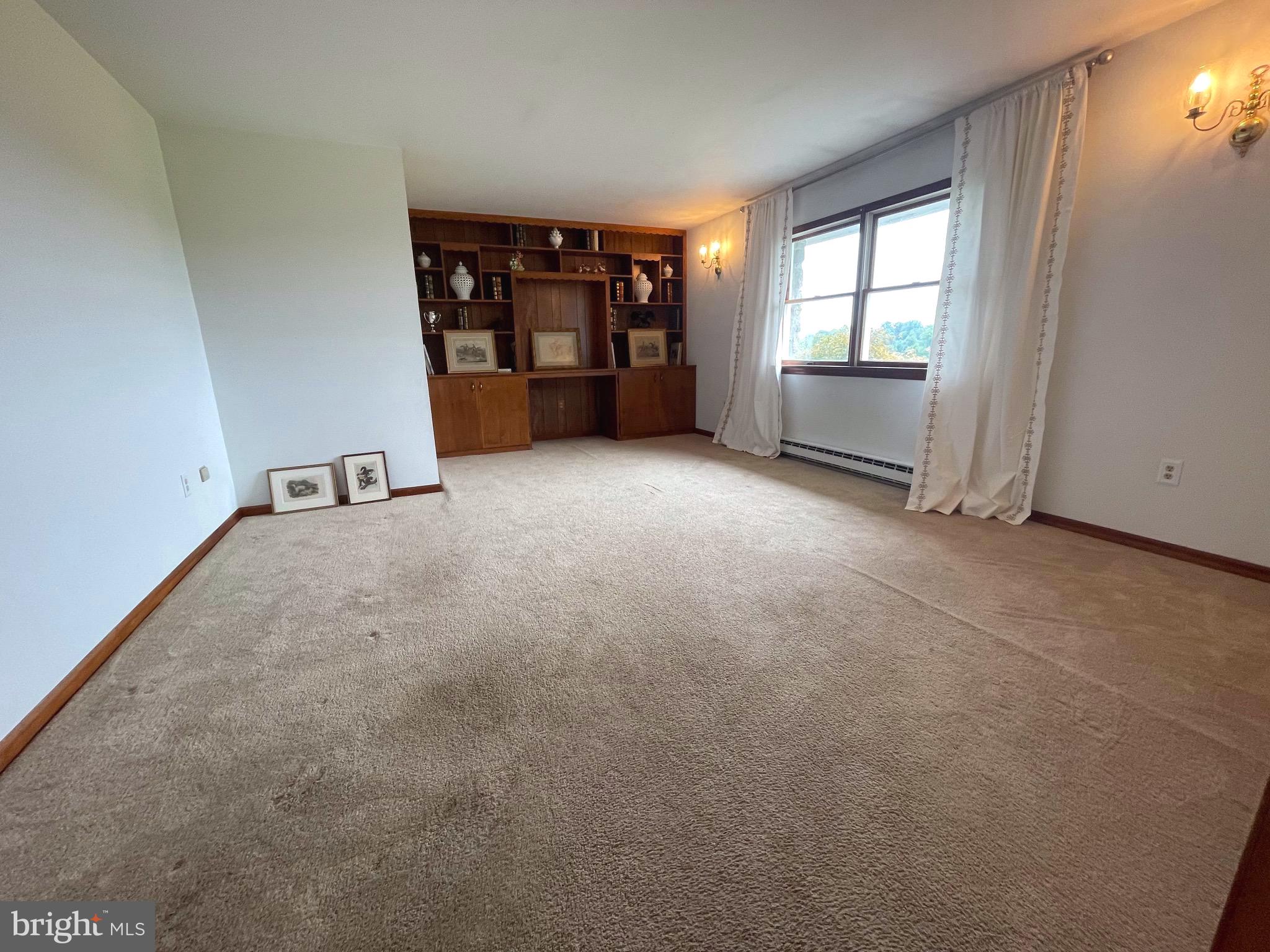 21133 Foxcroft Road Middleburg, VA 20117 - Photo 11 of 41 an empty room with a window and fireplace