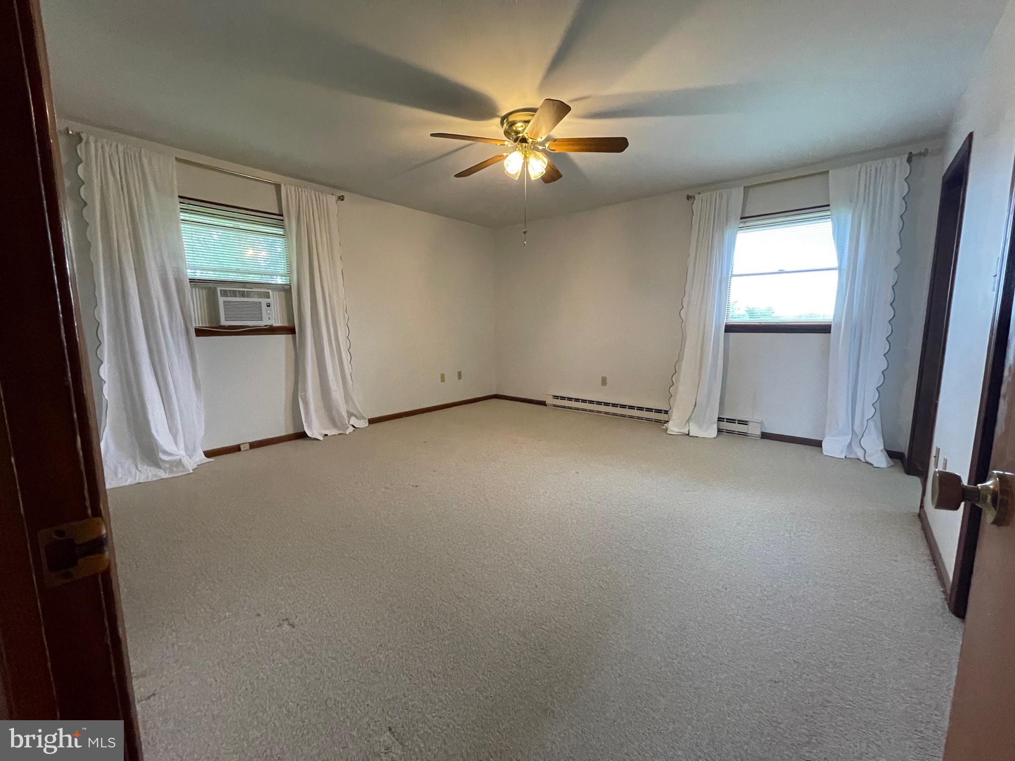 21133 Foxcroft Road Middleburg, VA 20117 - Photo 22 of 41 an empty room with windows and fan