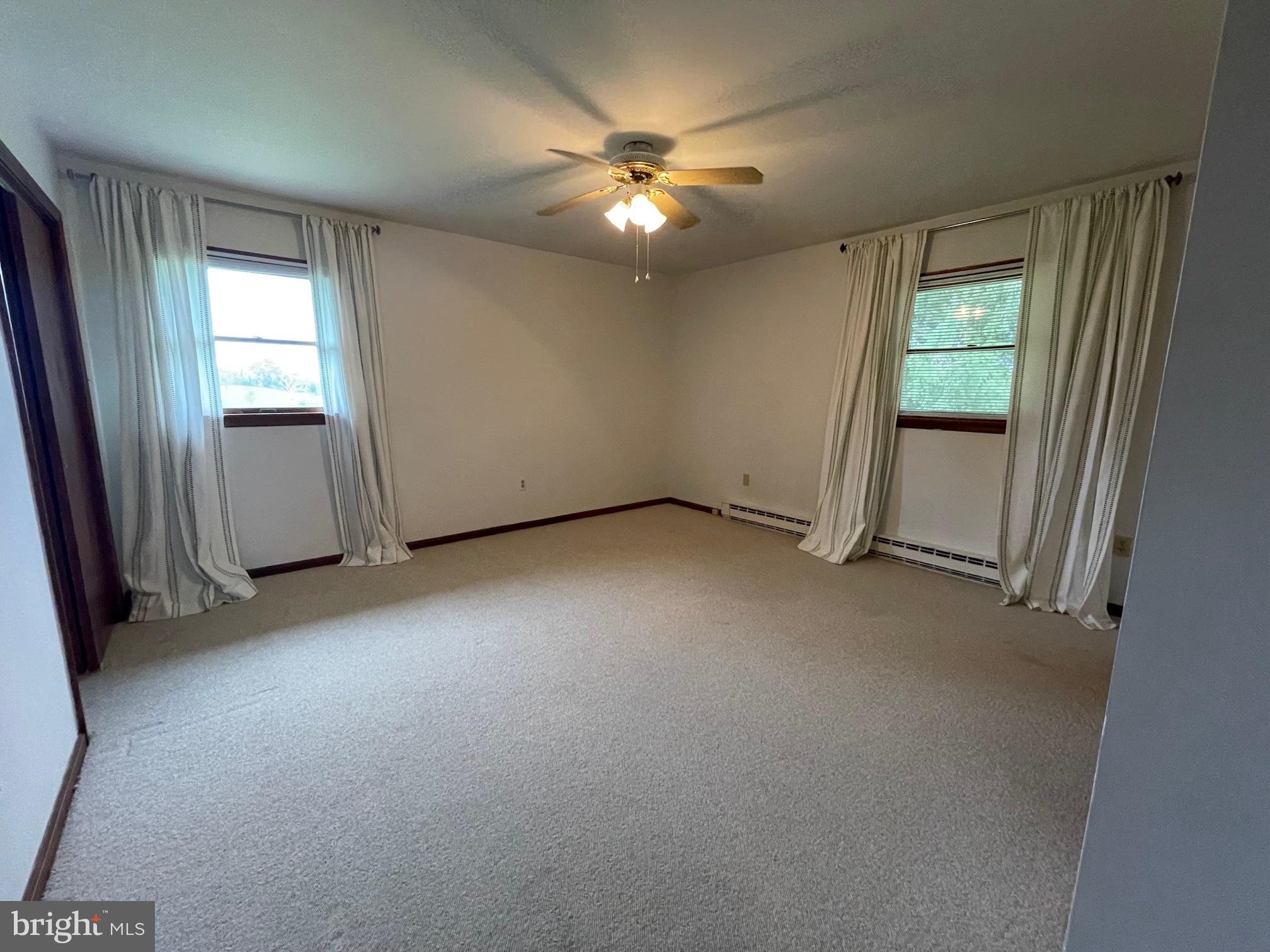 21133 Foxcroft Road Middleburg, VA 20117 - Photo 24 of 41 an empty room with windows and fan