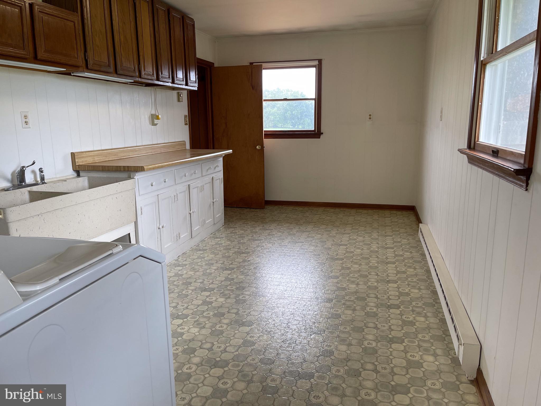 21133 Foxcroft Road Middleburg, VA 20117 - Photo 39 of 41 a kitchen with granite countertop a sink a stove and cabinets