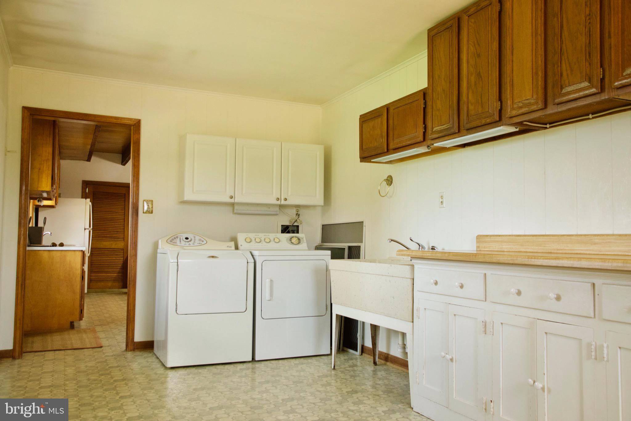 21133 Foxcroft Road Middleburg, VA 20117 - Photo 40 of 41 a utility room with cabinets washer and dryer