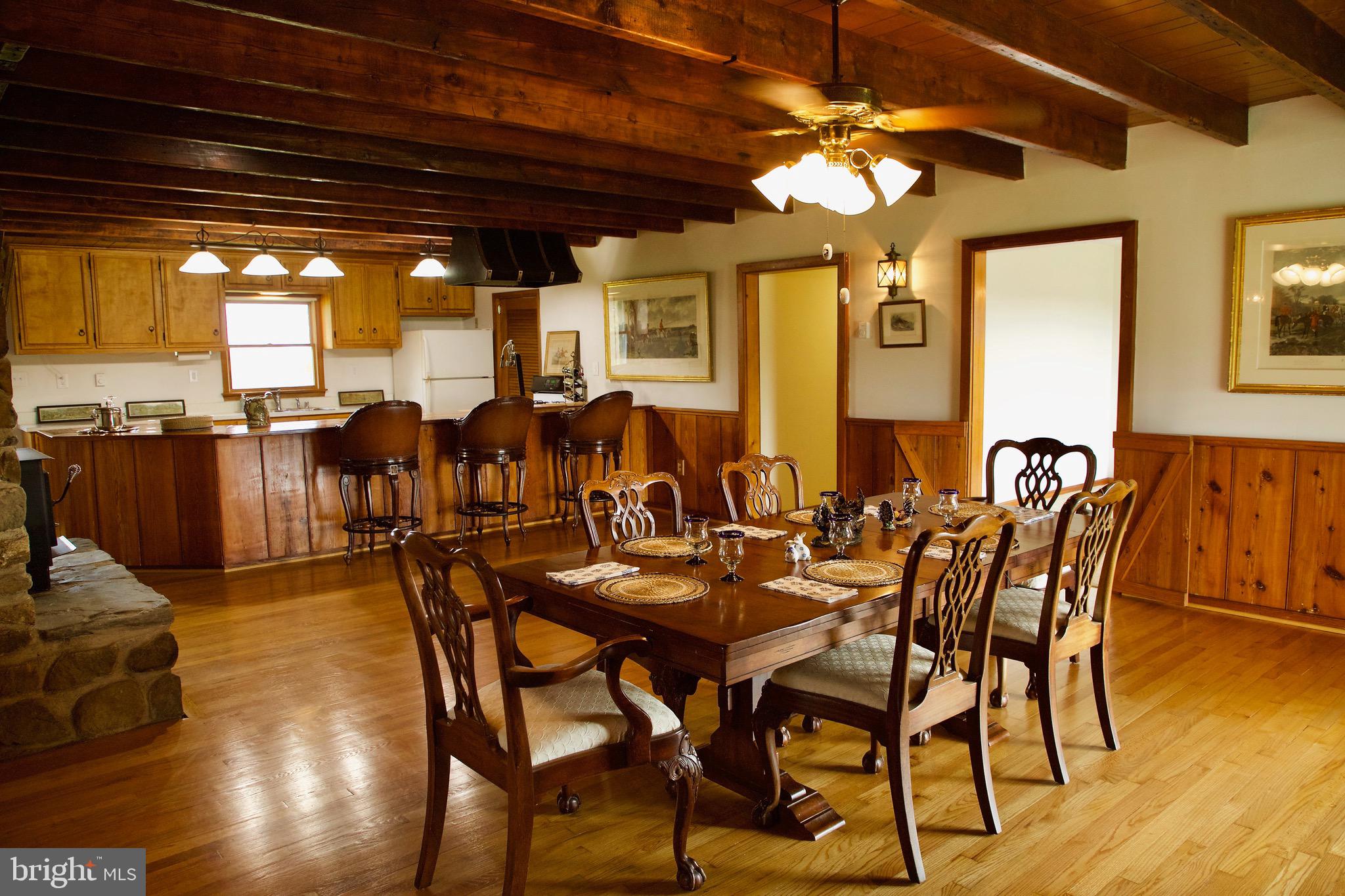 21133 Foxcroft Road Middleburg, VA 20117 - Photo 7 of 41 a dining room with furniture a chandelier and wooden floor