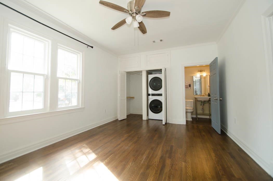 4572 Princeton Road Memphis, TN 38117 - Photo 11 of 24 Laundry area featuring stacked washer / dryer, ornamental molding, a ceiling fan, and dark wood-style floors