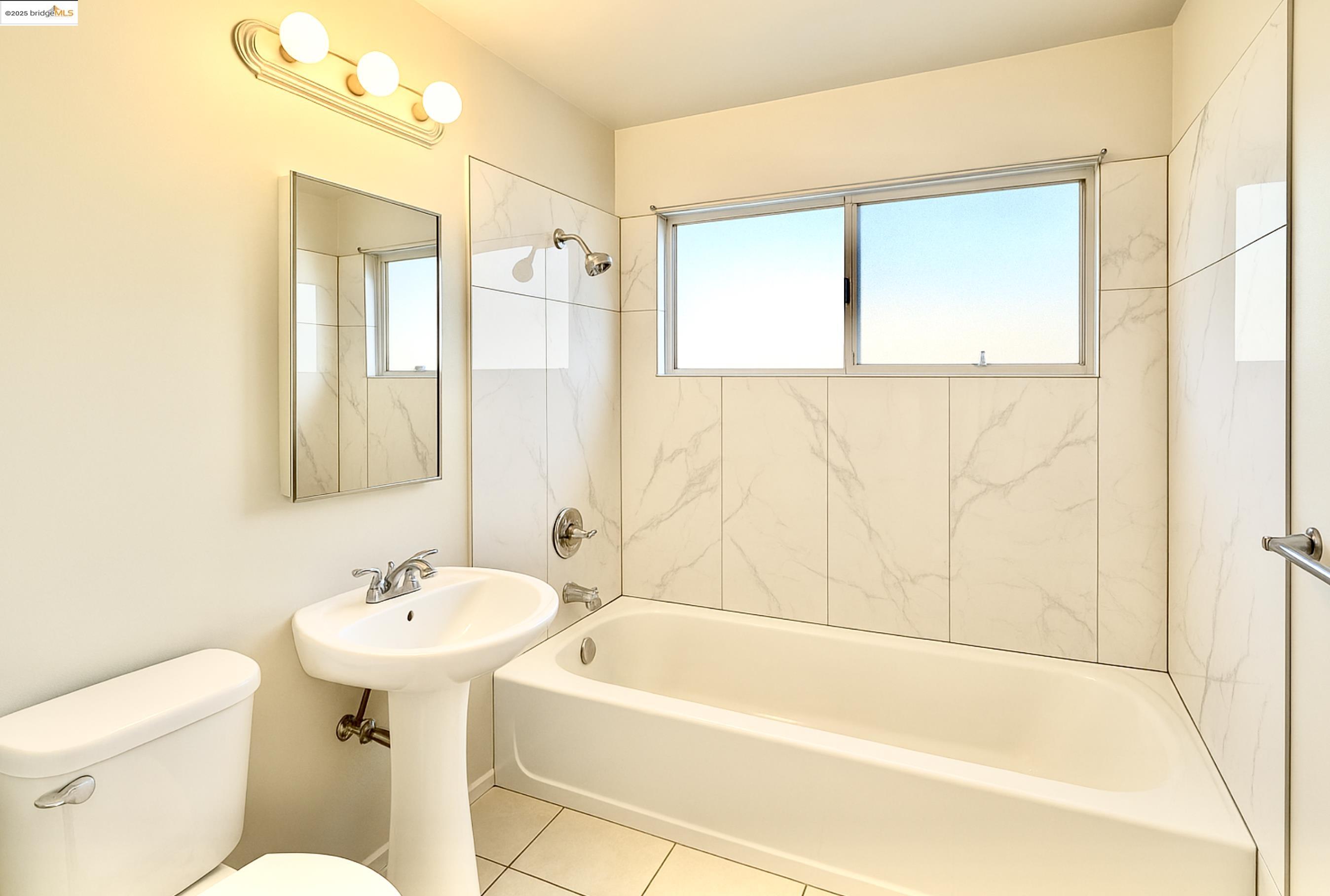 1728 Curtis Street Berkeley, CA 94702 - Photo 11 of 21 a bathroom with a sink toilet and shower