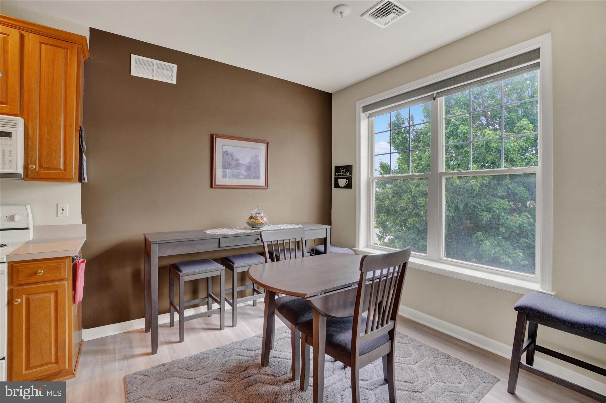 1010 Crest Way, Unit 304 York, PA 17403 - Photo 10 of 24 a view of a dining room with furniture window and outside view