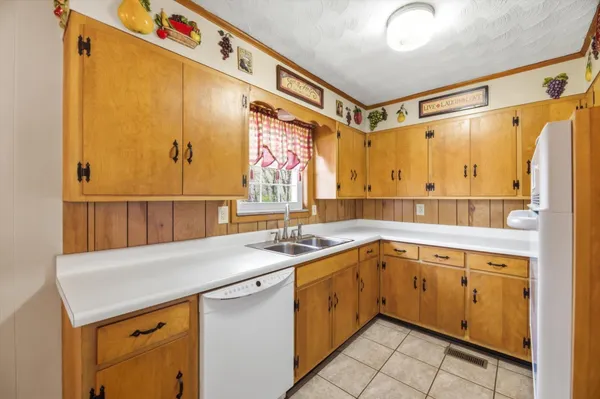 a kitchen with a sink a stove cabinets and a counter top space