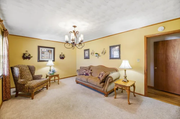 a living room with furniture and a chandelier