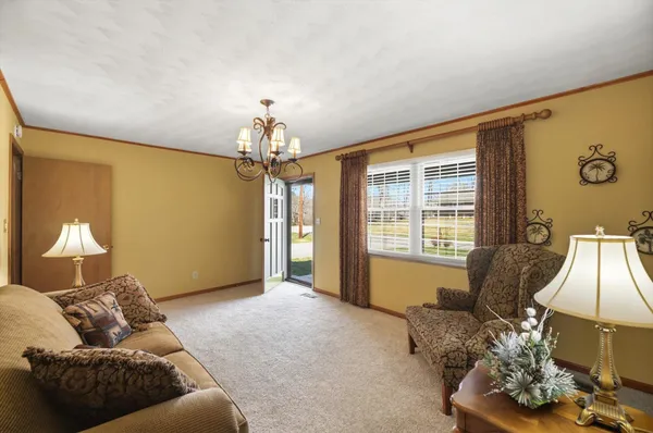 a living room with furniture and a chandelier