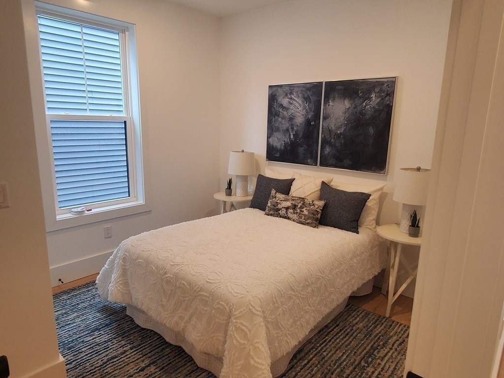 9 Greenmount Street, Unit 2 Boston, MA 02125 - Photo 6 of 15 a bedroom with a bed and a window