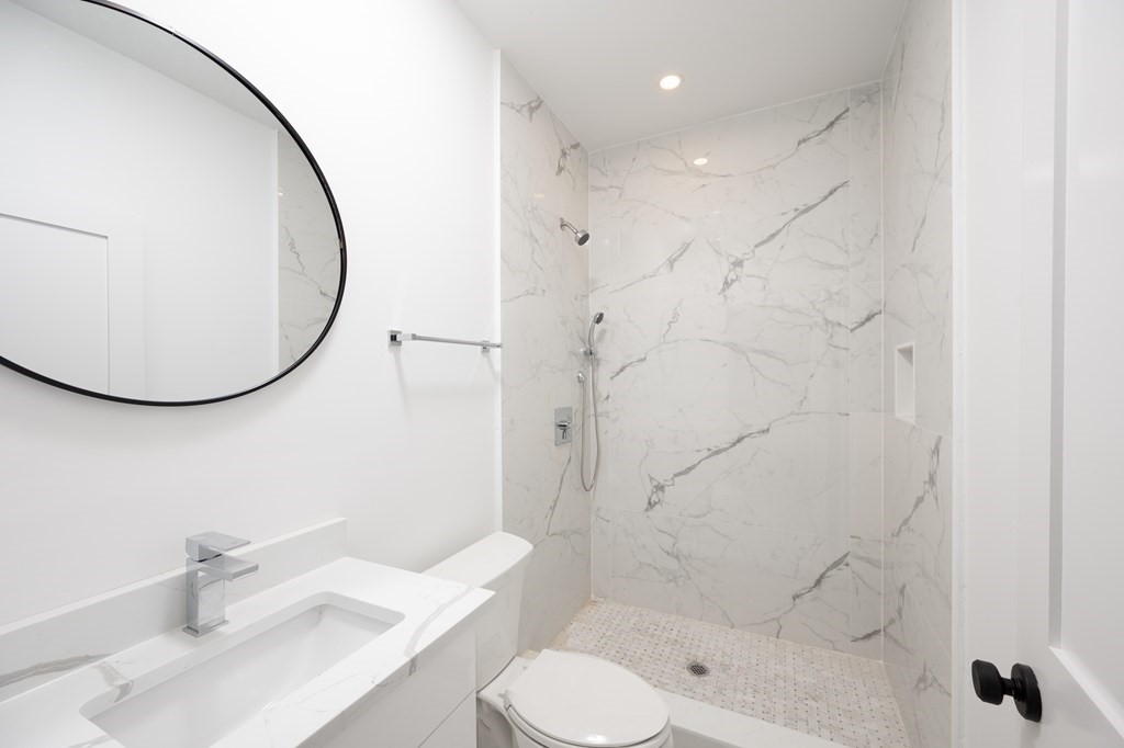 9 Greenmount Street, Unit 2 Boston, MA 02125 - Photo 10 of 15 a bathroom with a sink toilet and shower