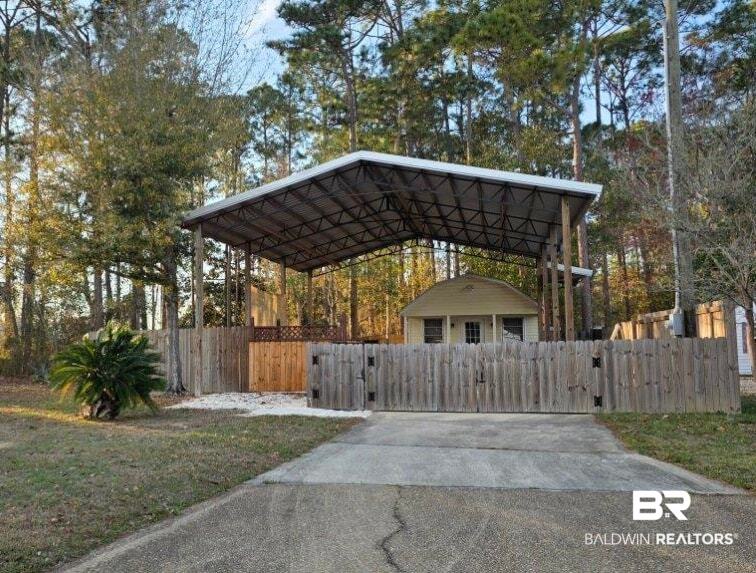 182 Defuniak Loop Lillian, AL 36549 - Photo 2 of 21 View of property exterior featuring a gate and a carport