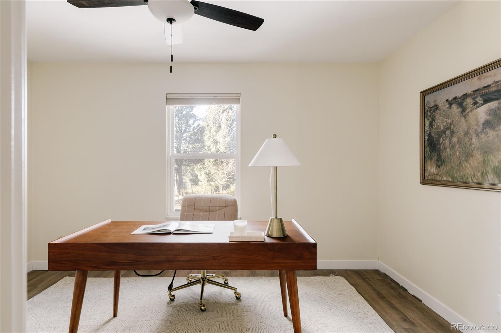 7580 South Lost Ranger Peak Littleton, CO 80127 - Photo 11 of 34 a view of a workspace with a table and a window