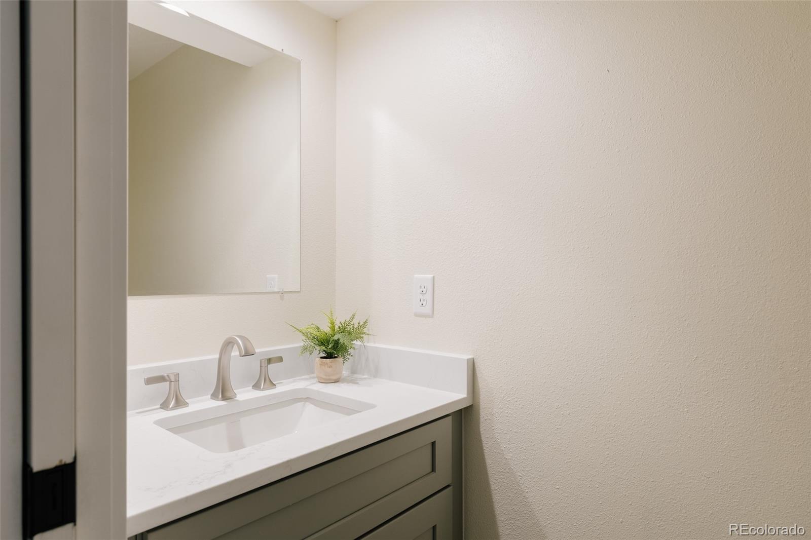 7580 South Lost Ranger Peak Littleton, CO 80127 - Photo 12 of 34 a bathroom with a sink and a mirror