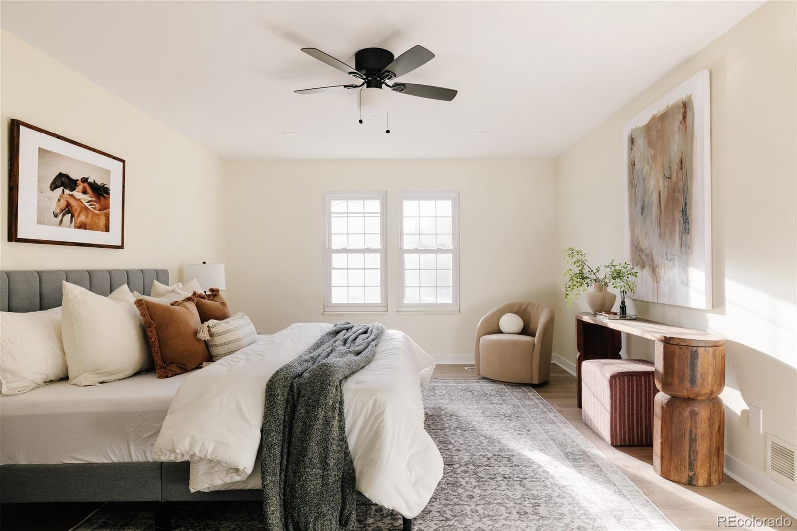 7580 South Lost Ranger Peak Littleton, CO 80127 - Photo 13 of 34 a bedroom with a bed and a couch