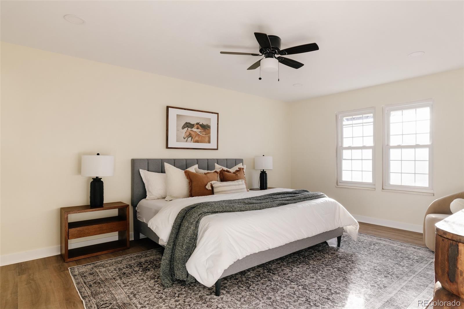 7580 South Lost Ranger Peak Littleton, CO 80127 - Photo 14 of 34 a bedroom with a bed a couch and a window