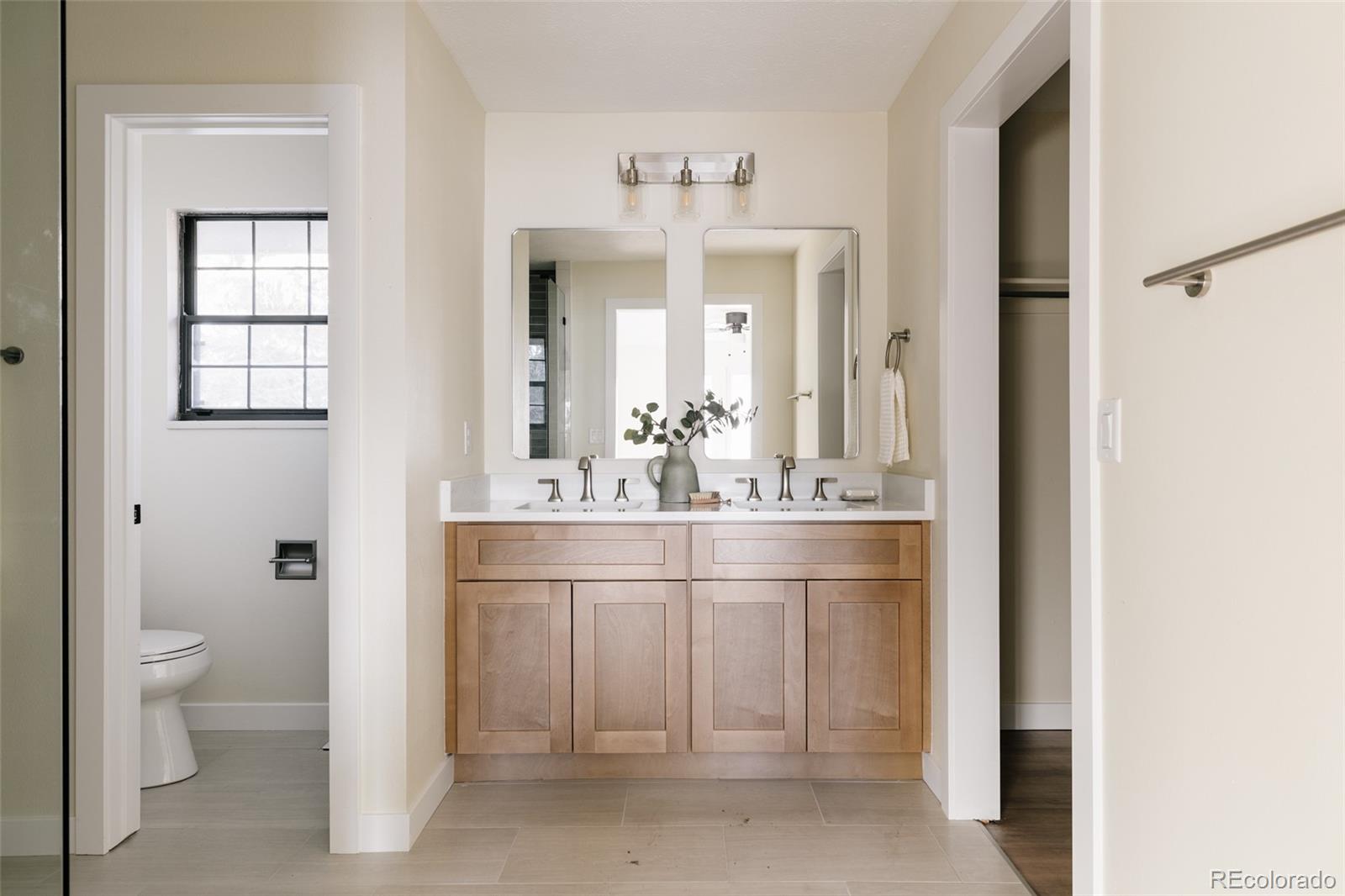 7580 South Lost Ranger Peak Littleton, CO 80127 - Photo 16 of 34 a bathroom with a sink vanity and a mirror
