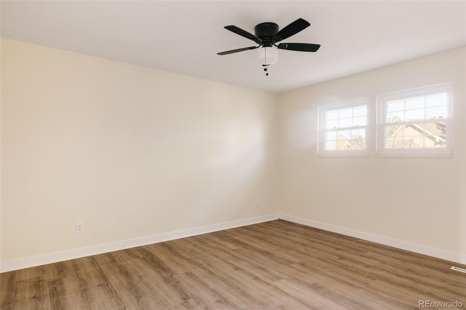 7580 South Lost Ranger Peak Littleton, CO 80127 - Photo 19 of 34 an empty room with wooden floor and windows