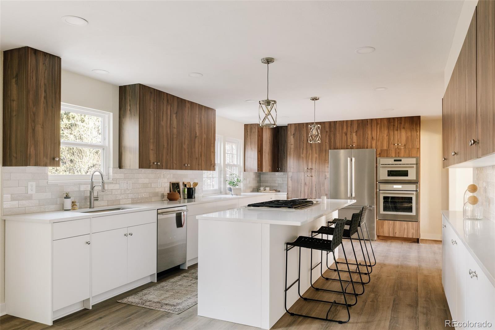 7580 South Lost Ranger Peak Littleton, CO 80127 - Photo 2 of 34 a kitchen with stainless steel appliances a sink stove and cabinets