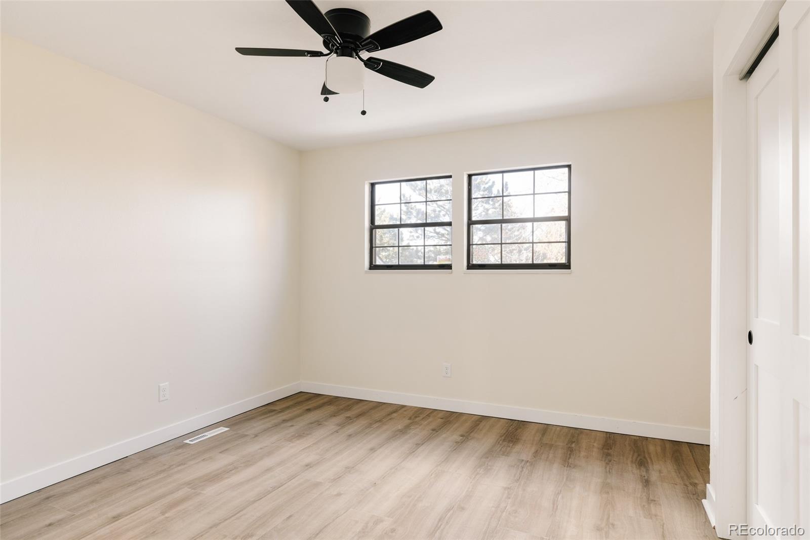 7580 South Lost Ranger Peak Littleton, CO 80127 - Photo 21 of 34 an empty room with a window and wooden floor