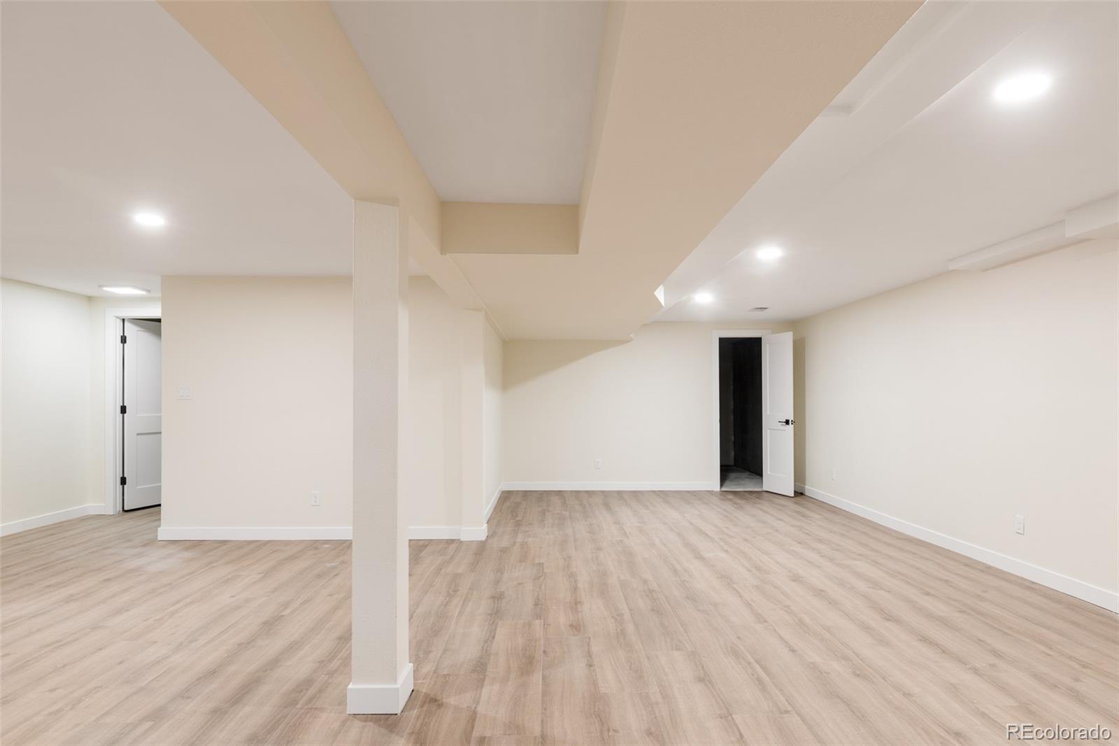 7580 South Lost Ranger Peak Littleton, CO 80127 - Photo 24 of 34 an empty room with wooden floor and windows