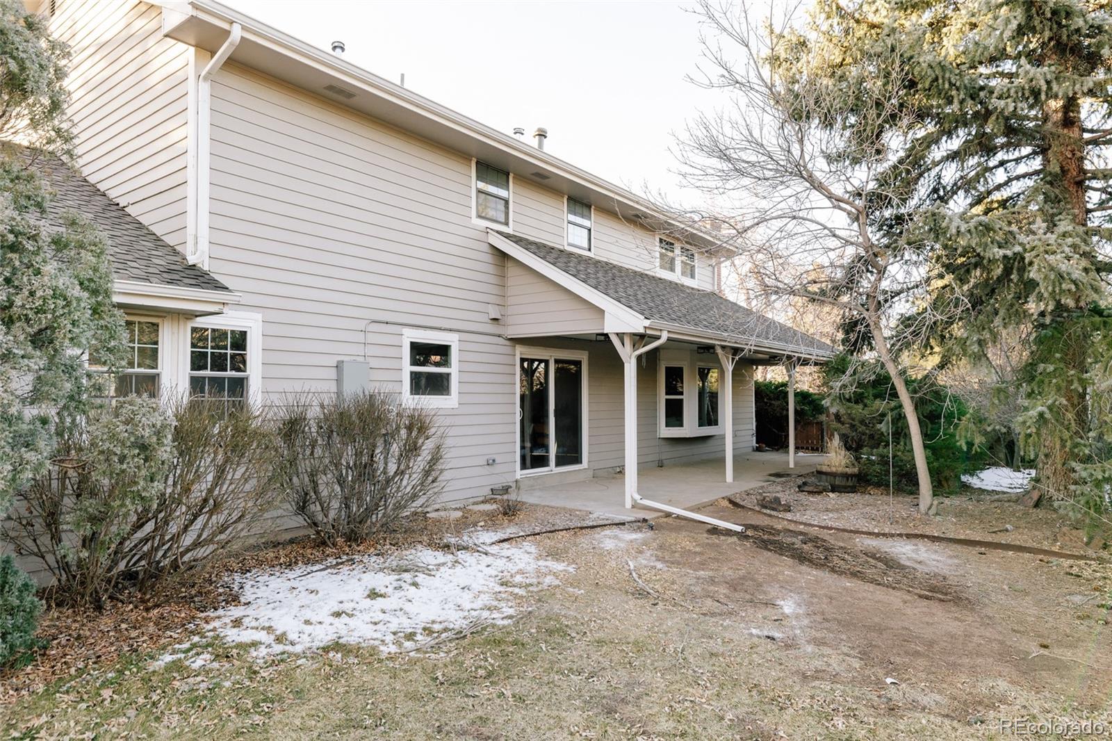 7580 South Lost Ranger Peak Littleton, CO 80127 - Photo 27 of 34 a view of a house with a yard and tree