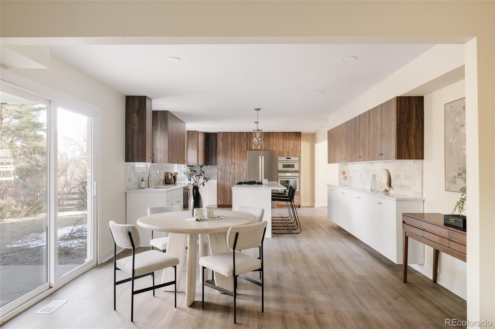 7580 South Lost Ranger Peak Littleton, CO 80127 - Photo 6 of 34 a dining room with furniture and wooden floor