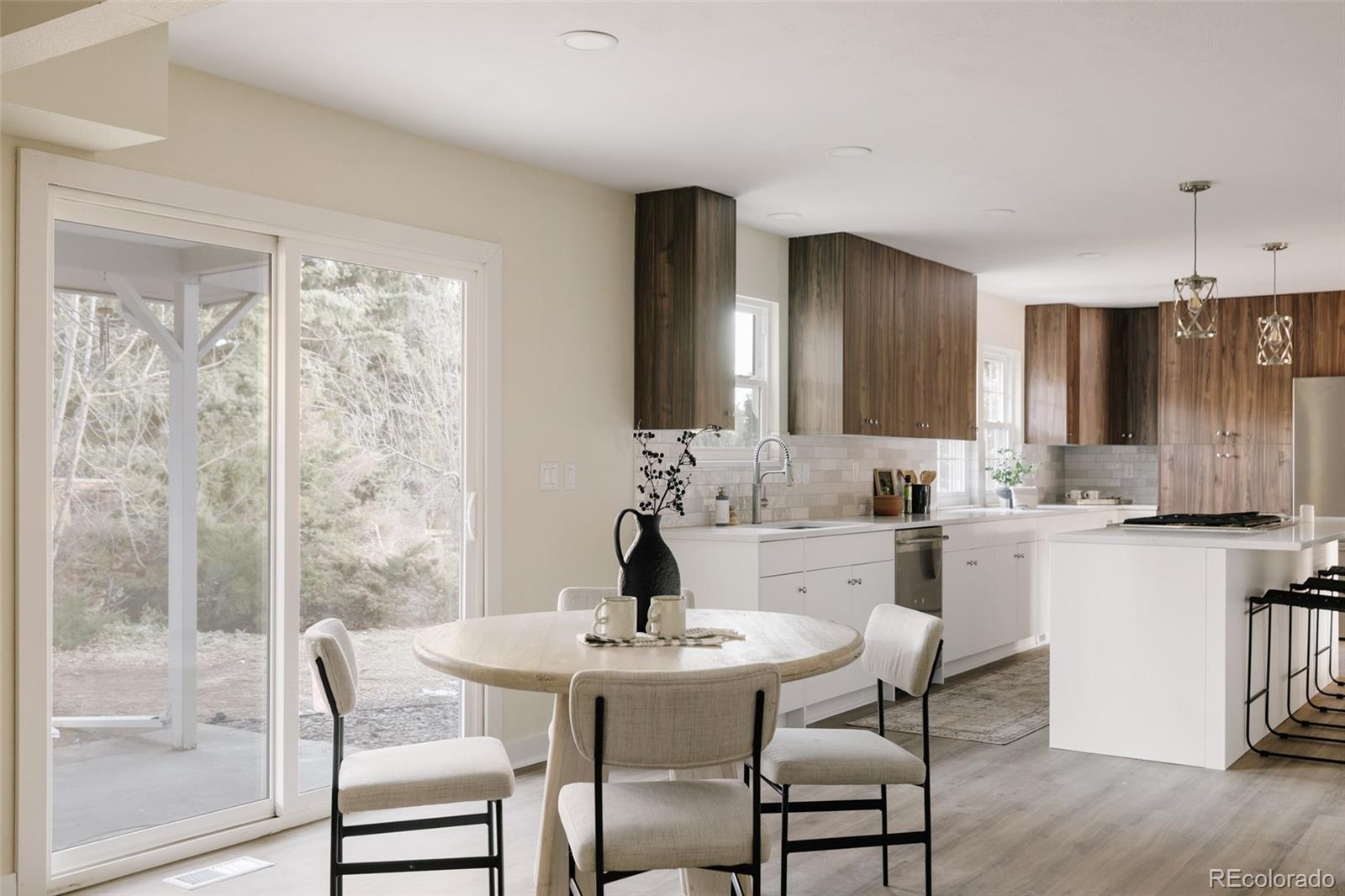 7580 South Lost Ranger Peak Littleton, CO 80127 - Photo 8 of 34 a kitchen with a table chairs sink and cabinets