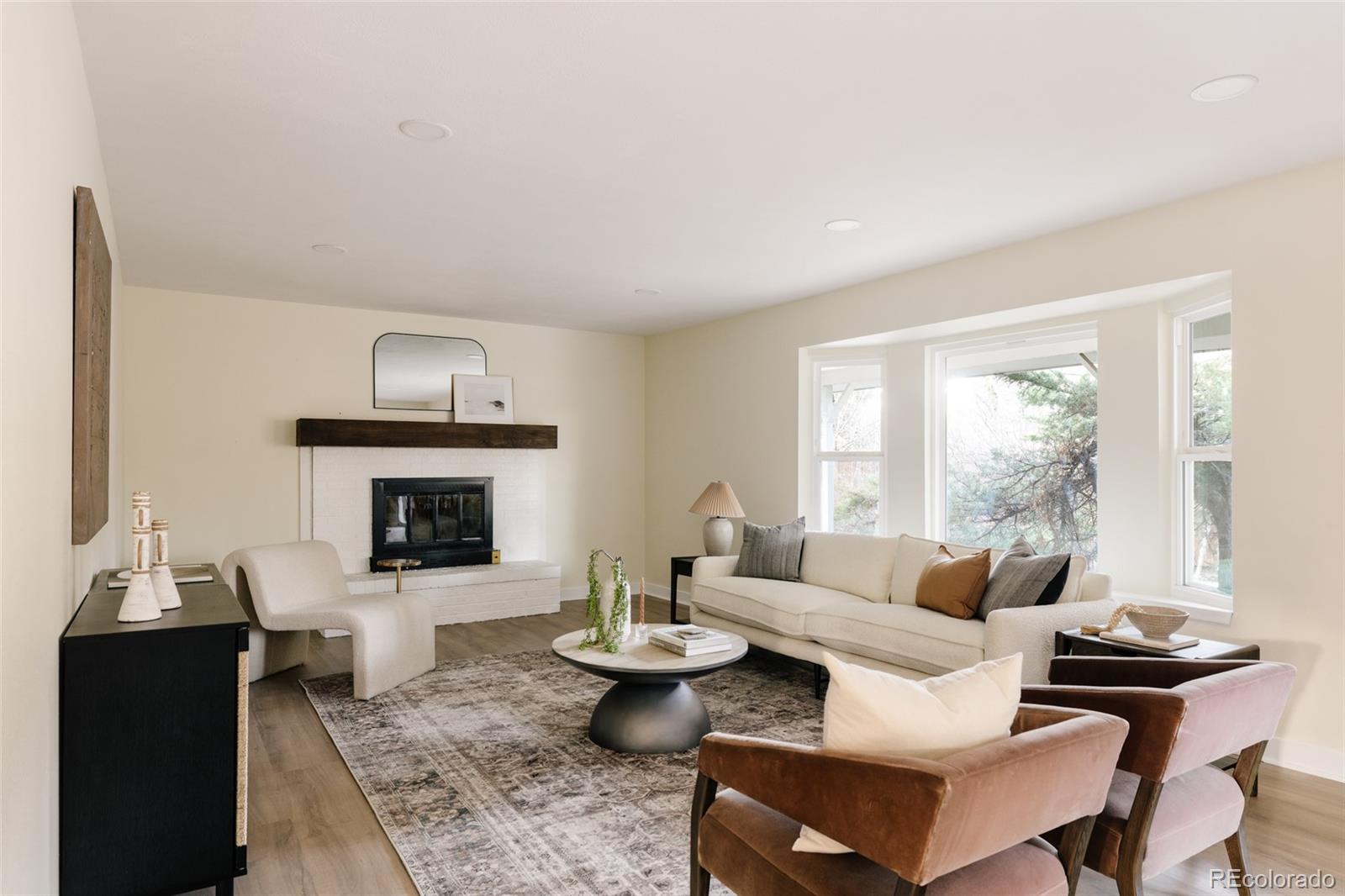 7580 South Lost Ranger Peak Littleton, CO 80127 - Photo 9 of 34 a living room with furniture and a fireplace