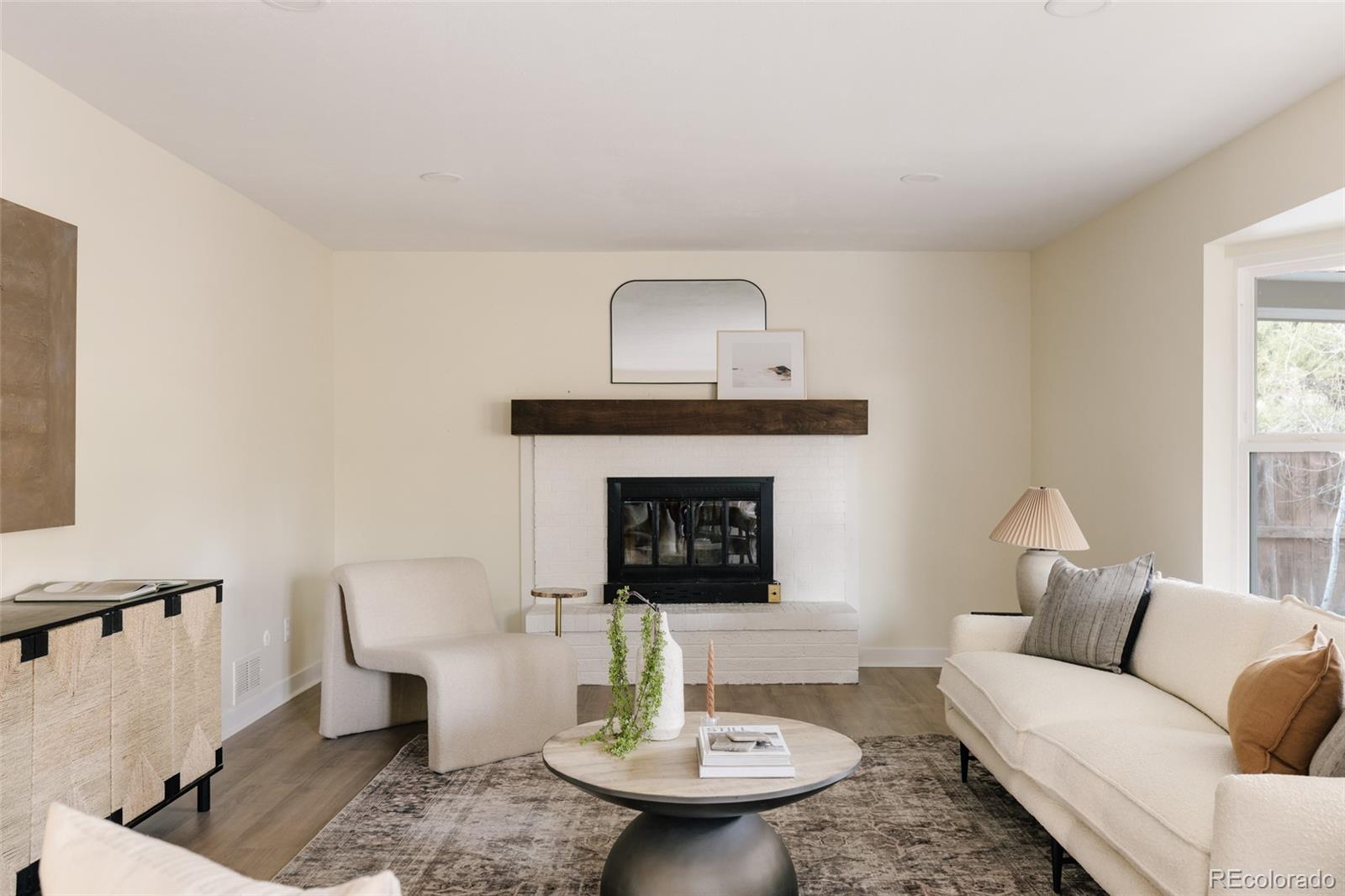 7580 South Lost Ranger Peak Littleton, CO 80127 - Photo 10 of 34 a living room with furniture and a fireplace