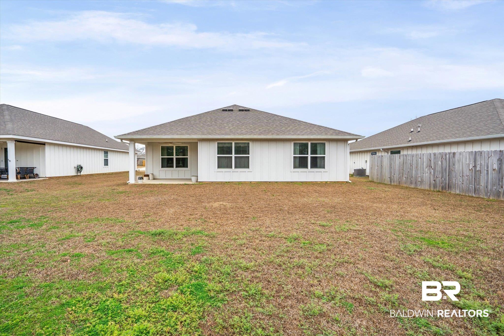 17041 Muse Street Loxley, AL 36551 - Photo 27 of 44 Back of house featuring a patio area, board and batten siding, and a shingled roof