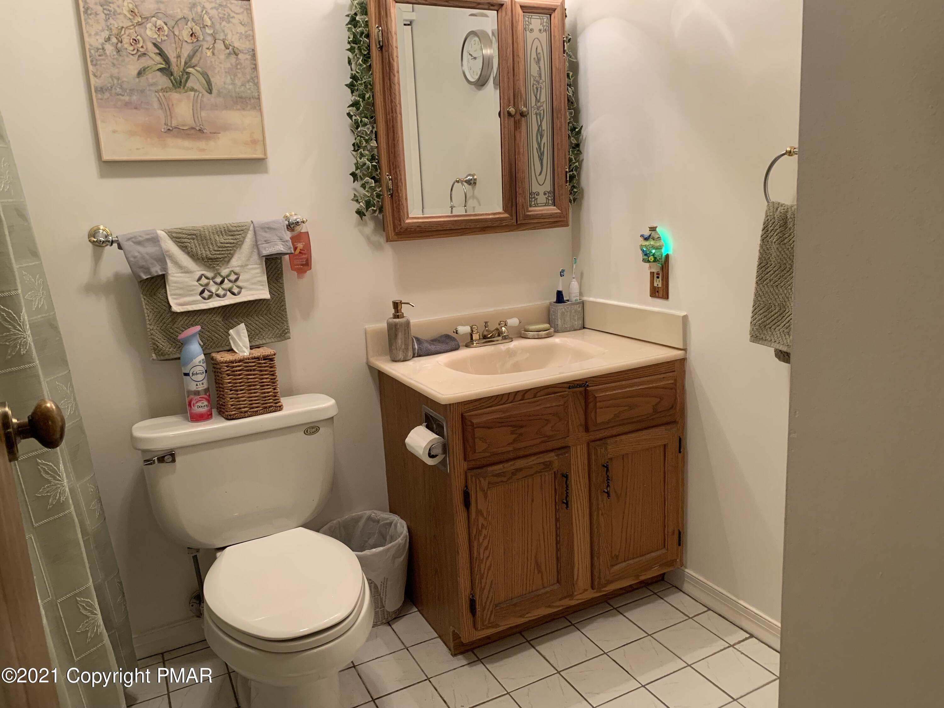 338 Laurel Lake Road Bartonsville, PA 18321 - Photo 16 of 27 a bathroom with a toilet sink and mirror