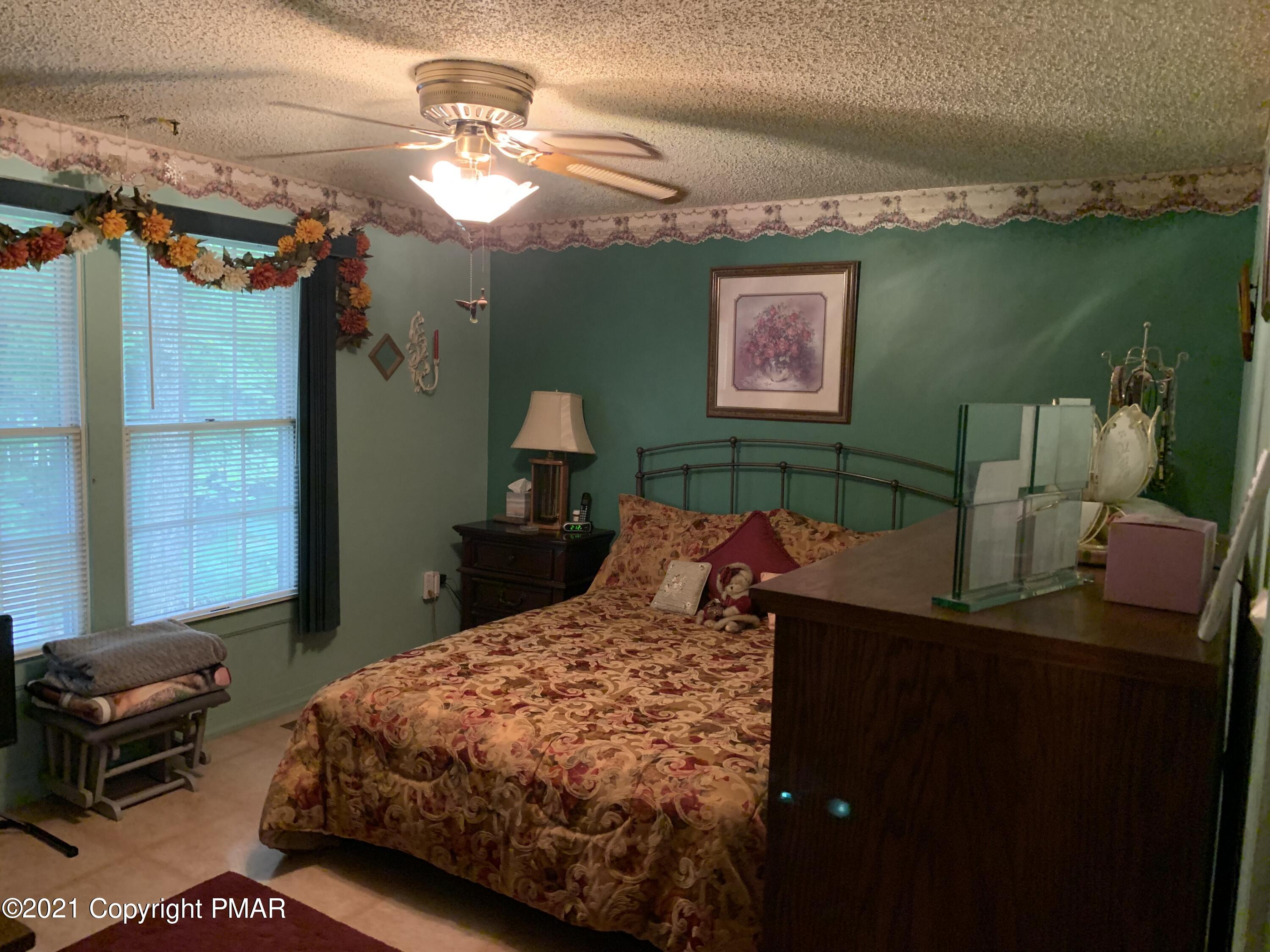 338 Laurel Lake Road Bartonsville, PA 18321 - Photo 19 of 27 a bedroom with a bed dresser and a window