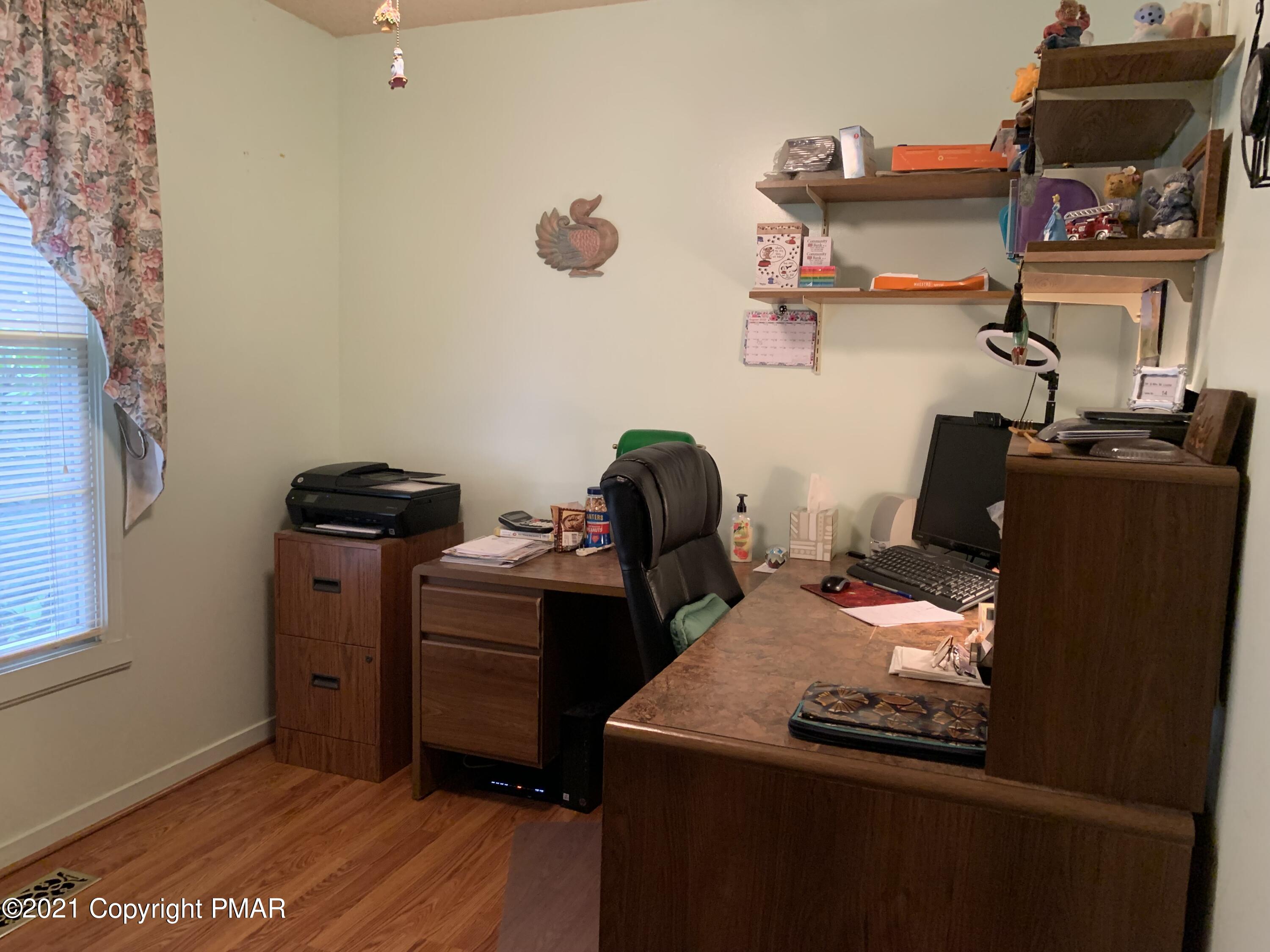 338 Laurel Lake Road Bartonsville, PA 18321 - Photo 24 of 27 a view of a workspace with furniture and a window