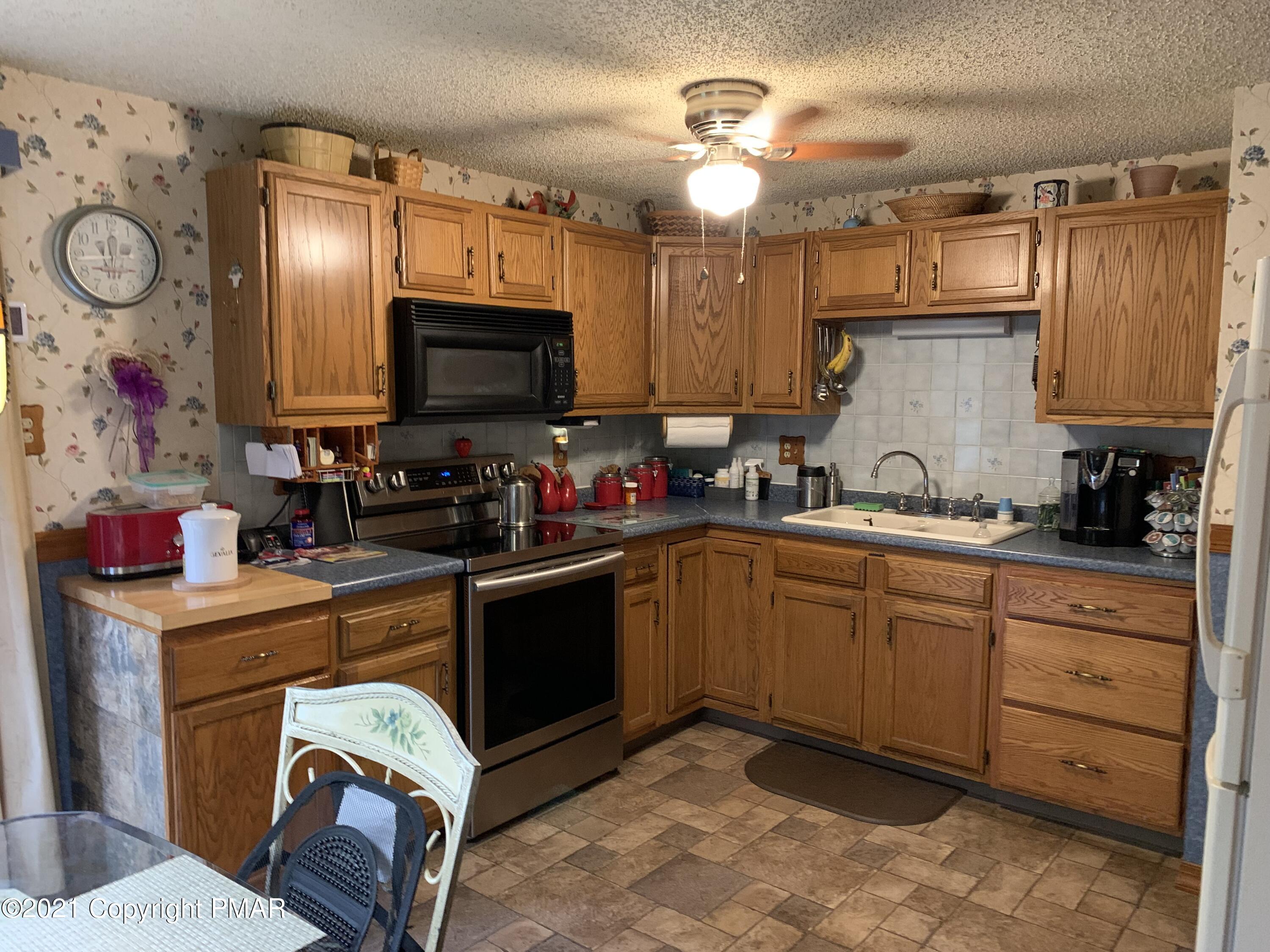 338 Laurel Lake Road Bartonsville, PA 18321 - Photo 3 of 27 a kitchen with cabinets a sink and appliances