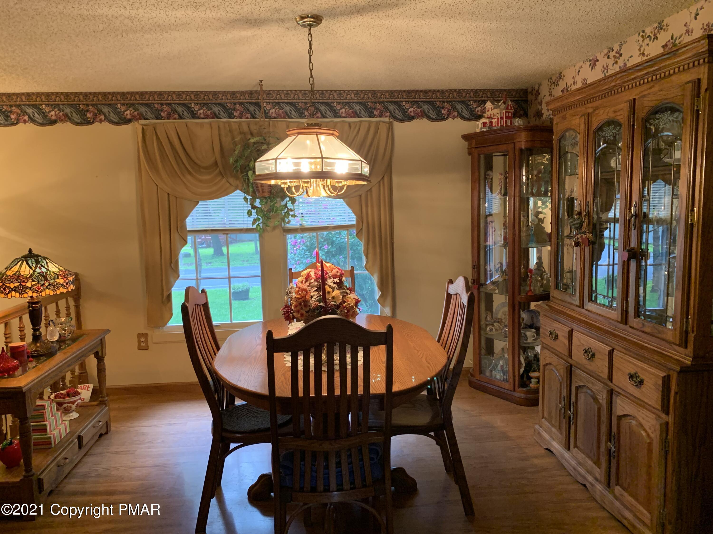 338 Laurel Lake Road Bartonsville, PA 18321 - Photo 5 of 27 a view of a dining room with furniture window and wooden floor