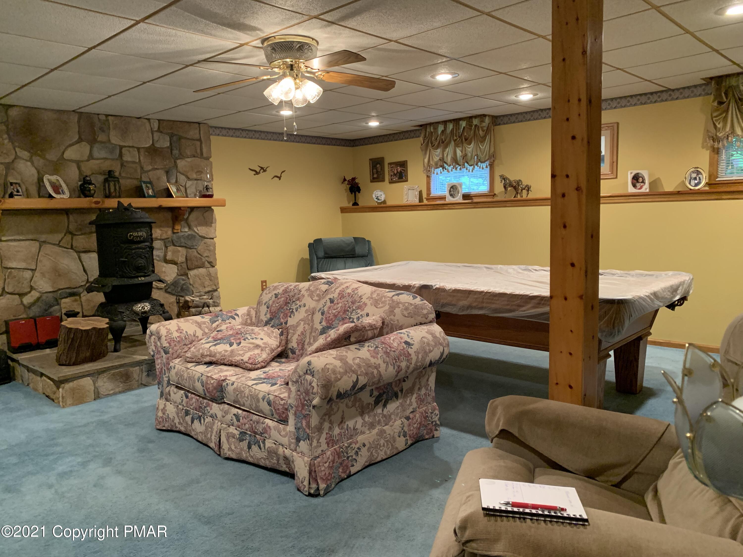338 Laurel Lake Road Bartonsville, PA 18321 - Photo 7 of 27 a bedroom with furniture and a chandelier
