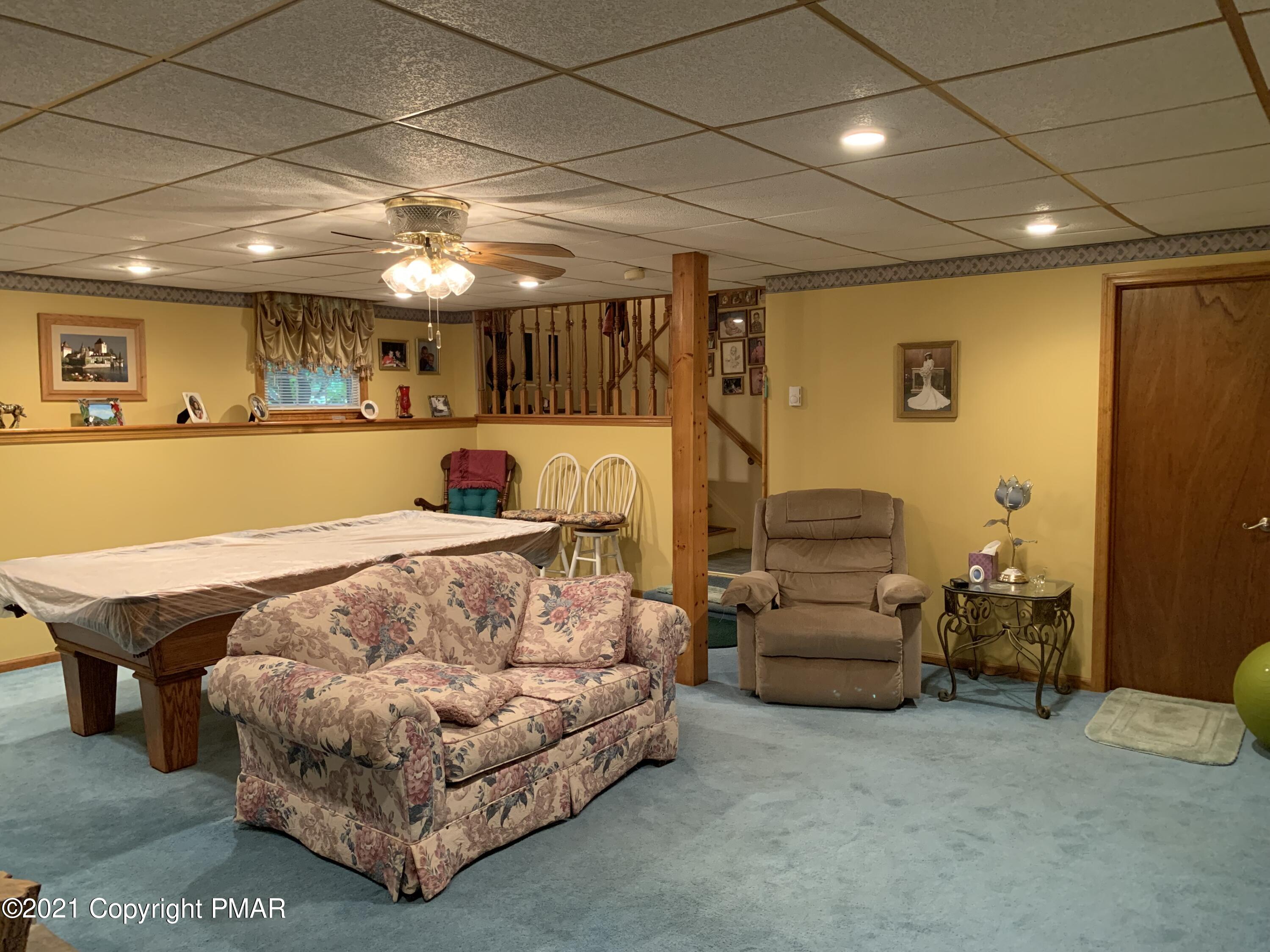 338 Laurel Lake Road Bartonsville, PA 18321 - Photo 8 of 27 a living room with furniture and a flat screen tv
