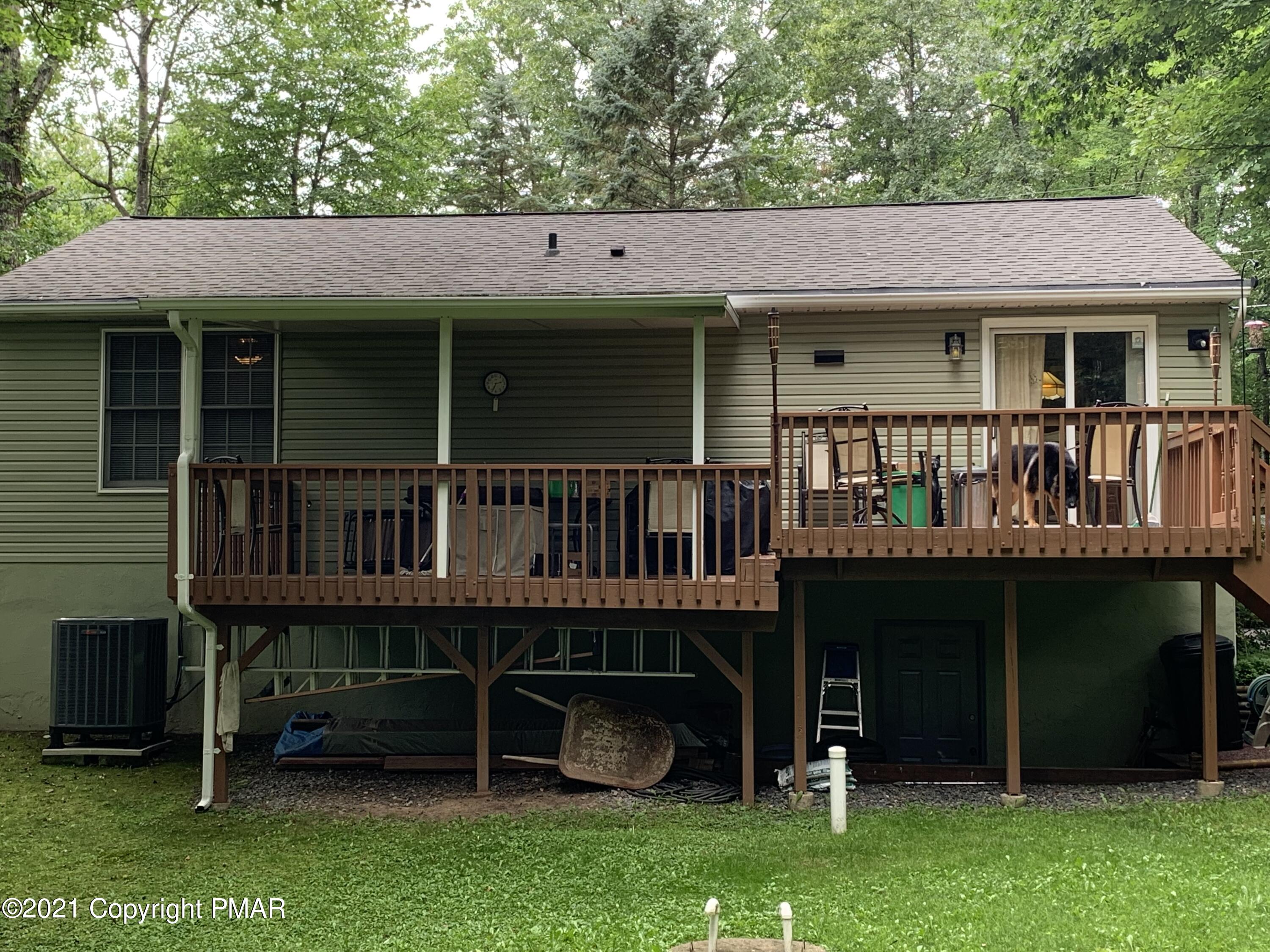 338 Laurel Lake Road Bartonsville, PA 18321 - Photo 10 of 27 a view of a house with a yard and a wooden deck