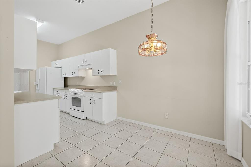 10 Chatham Place, Unit 10 Palm Coast, FL 32164 - Photo 11 of 23 a kitchen with white cabinets and white appliances