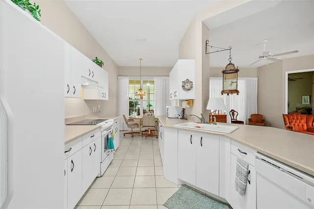 a kitchen with cabinets appliances and a window