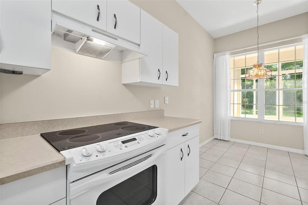 10 Chatham Place, Unit 10 Palm Coast, FL 32164 - Photo 14 of 23 a kitchen with cabinets appliances and a window