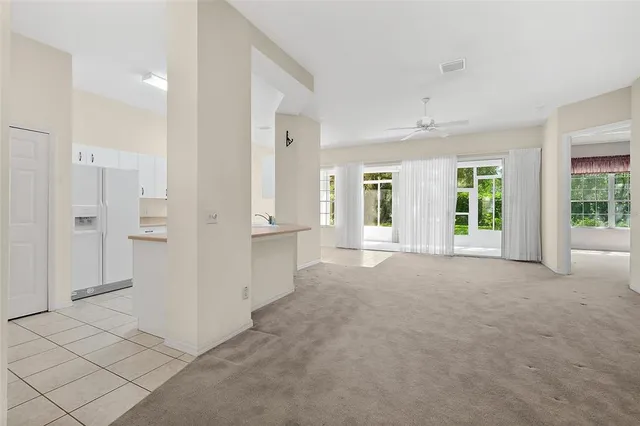 an empty room with fan and windows