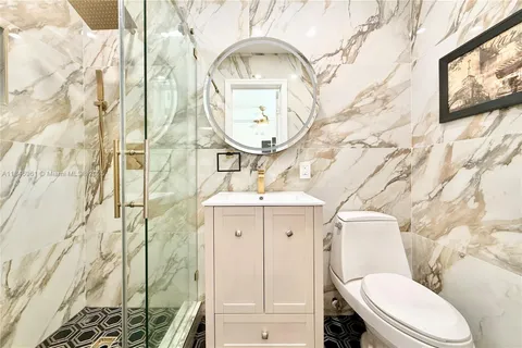 a bathroom with a toilet a sink and a mirror