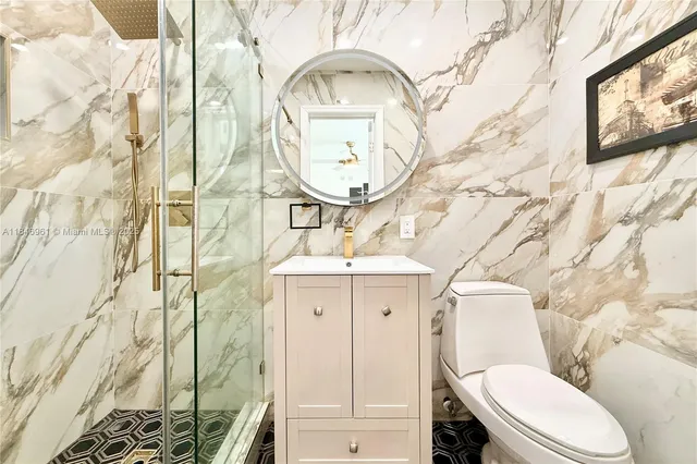 a bathroom with a toilet a sink and a mirror